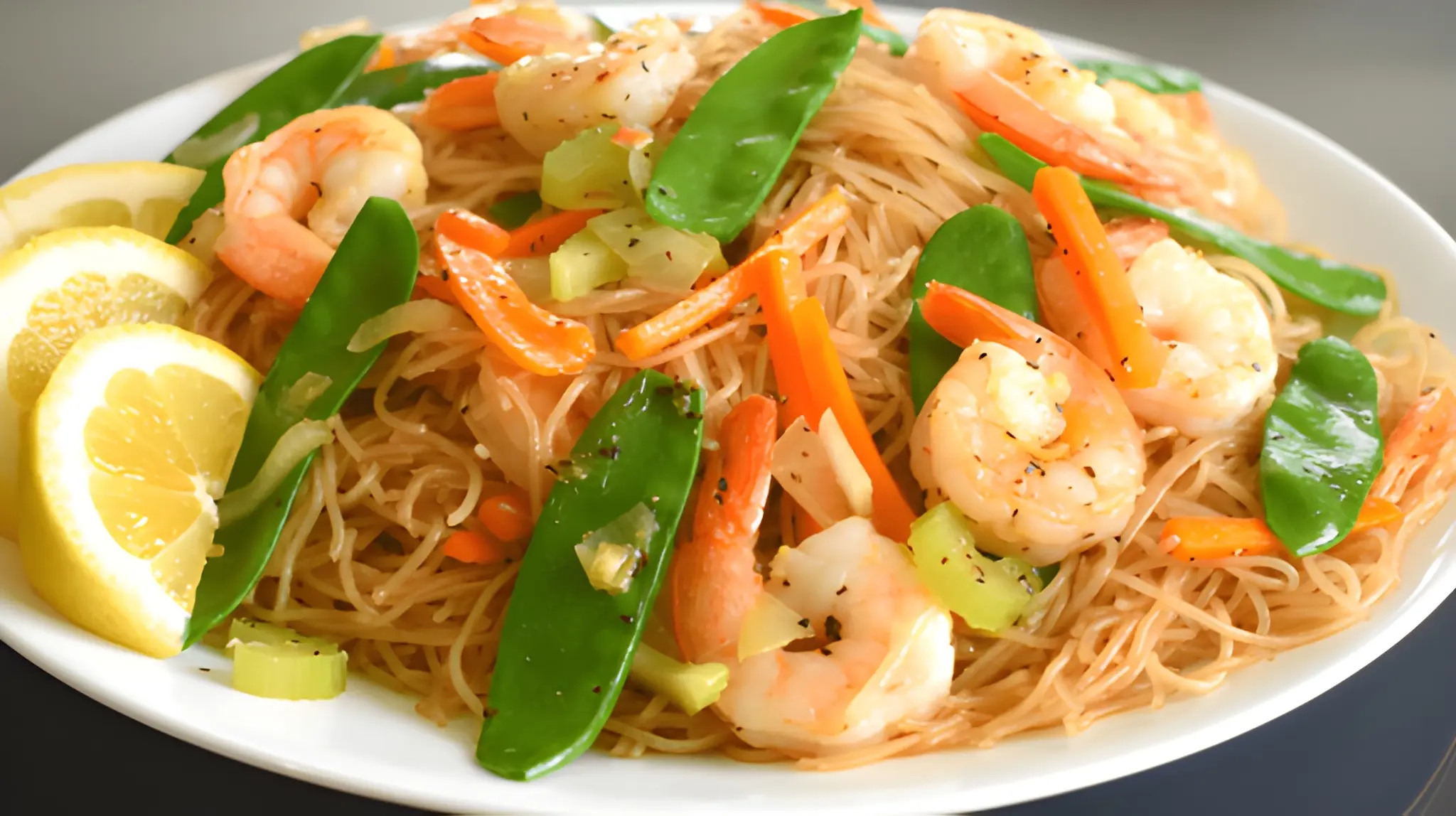 Pancit Bihon rice noodles with shrimp, snap peas, carrots, and lemon slices at Manila Good-Ha Filipino Chinese Fast Food in Union City, CA – Skiplyn